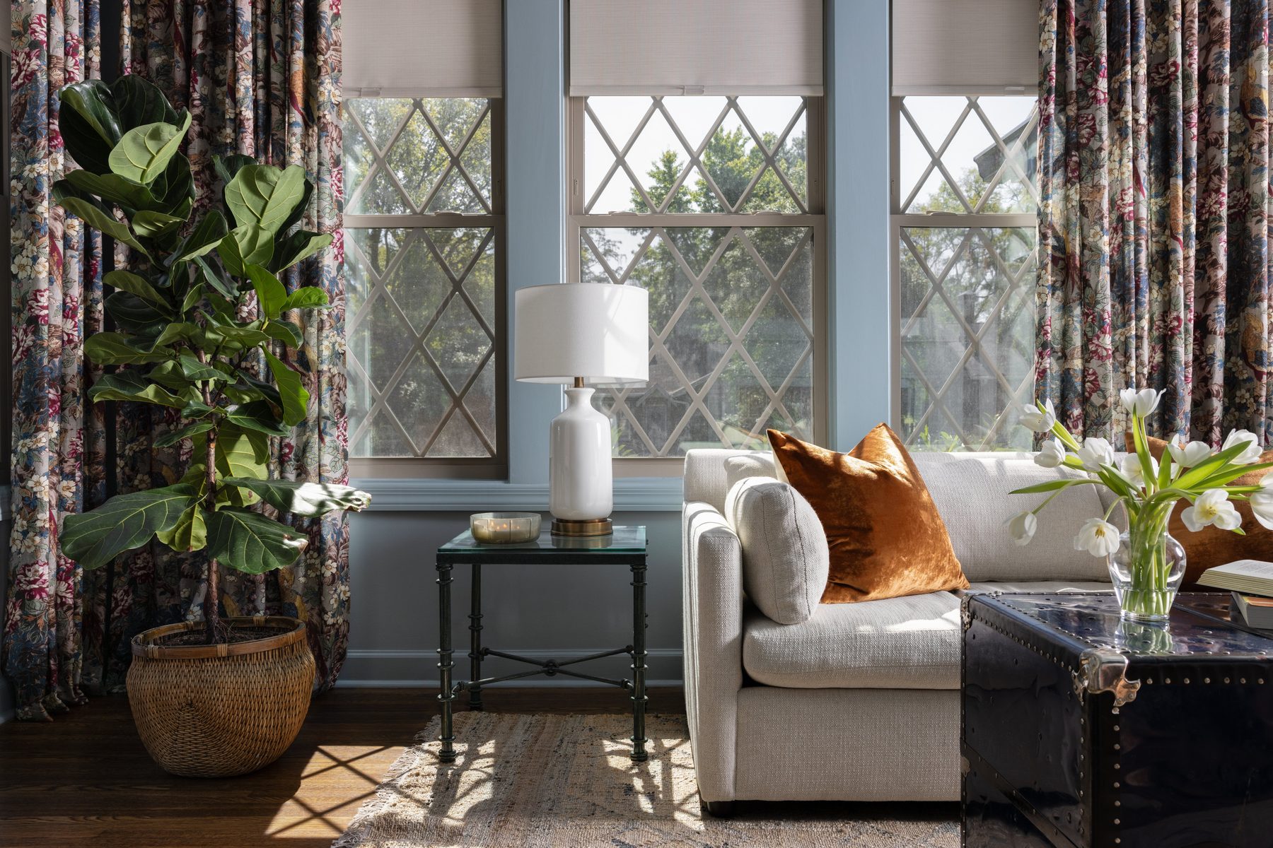 The full built-in wall with the hidden door open, the homeowner reaching for a shelf inside, the fireplace and leather recliner framing the room