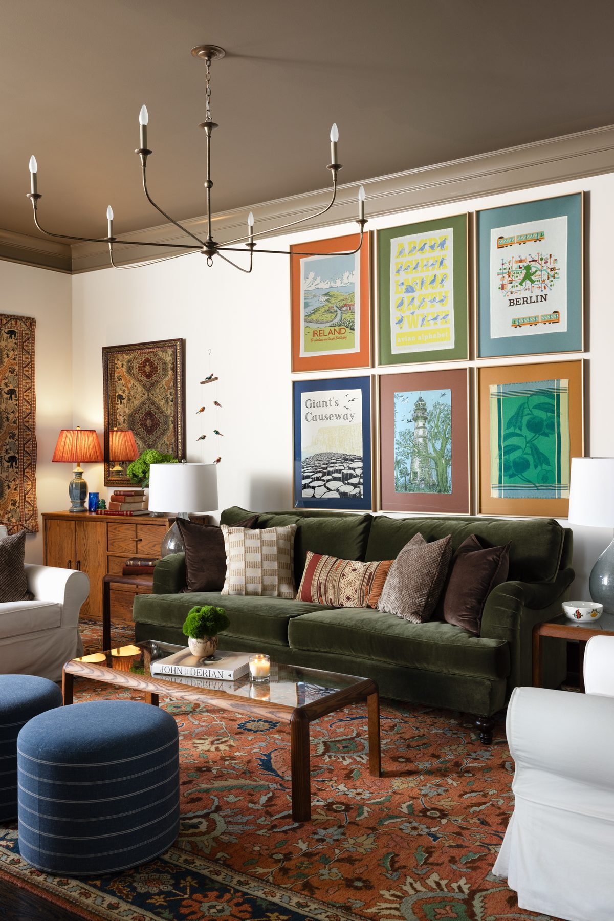 A collected living room built around the clients&rsquo; green sofa and giant rug, with vintage tables and secondhand lighting